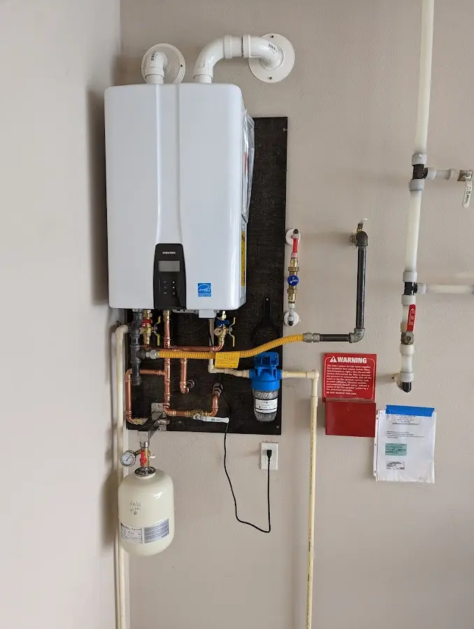 Professional plumber installing copper piping in a Warrington home